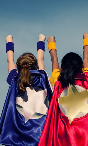 Photo of two children dressed as superheroes.