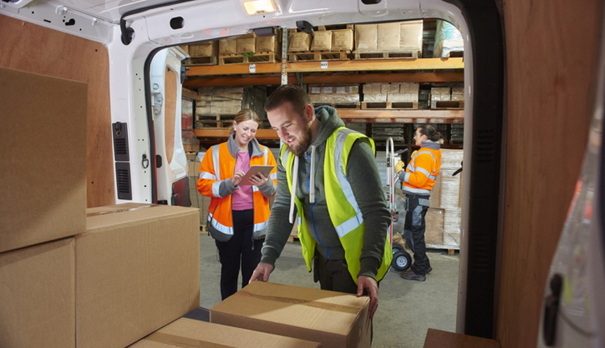 Man Unloading Boxes From Van