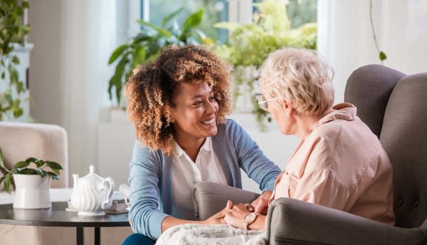 Older Lady Talking To Young Care Worker Older Lady Talking To Young Care Worker