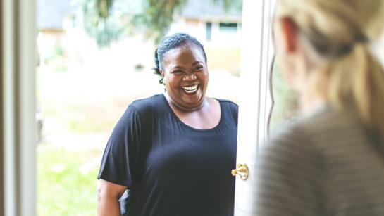 Lady Smiling At Front Door (1)