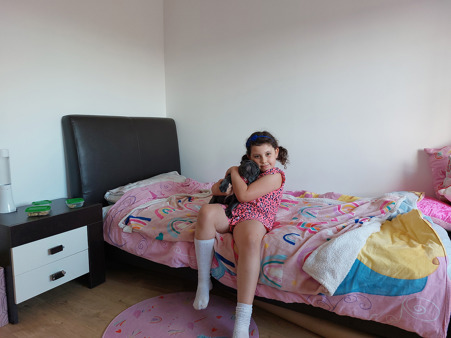 Daughter in new bedroom with dog