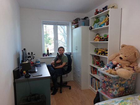 Son in bedroom with dog