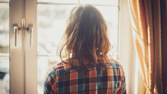 Woman Looking Out A Window