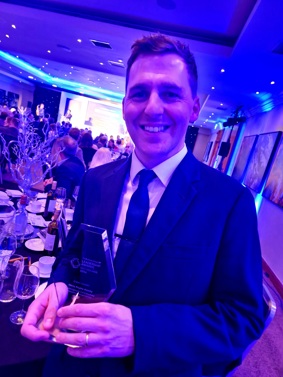 Chris holding his award